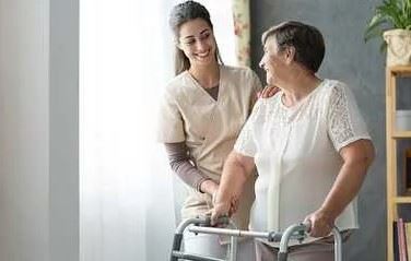 Nursing helping senior patient with walker